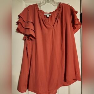 Dree shirt rose pink with ruffle sleeves and an option to button the top.